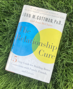 The Relationship Cure hardcover book on grass