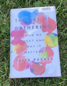 The Art of Gathering hardcover book on grass