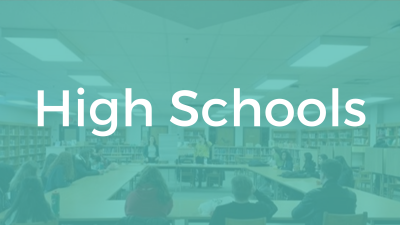 High Schools. Image: Students sitting around a large circle of tables.