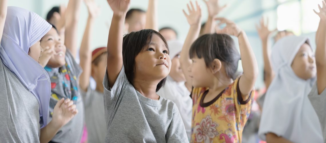 children raising hands
